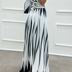 Elegant Shiloh striped maxi dress by The Whitmore Family, perfect for wedding guests, featuring a flowing silhouette and stylish design.