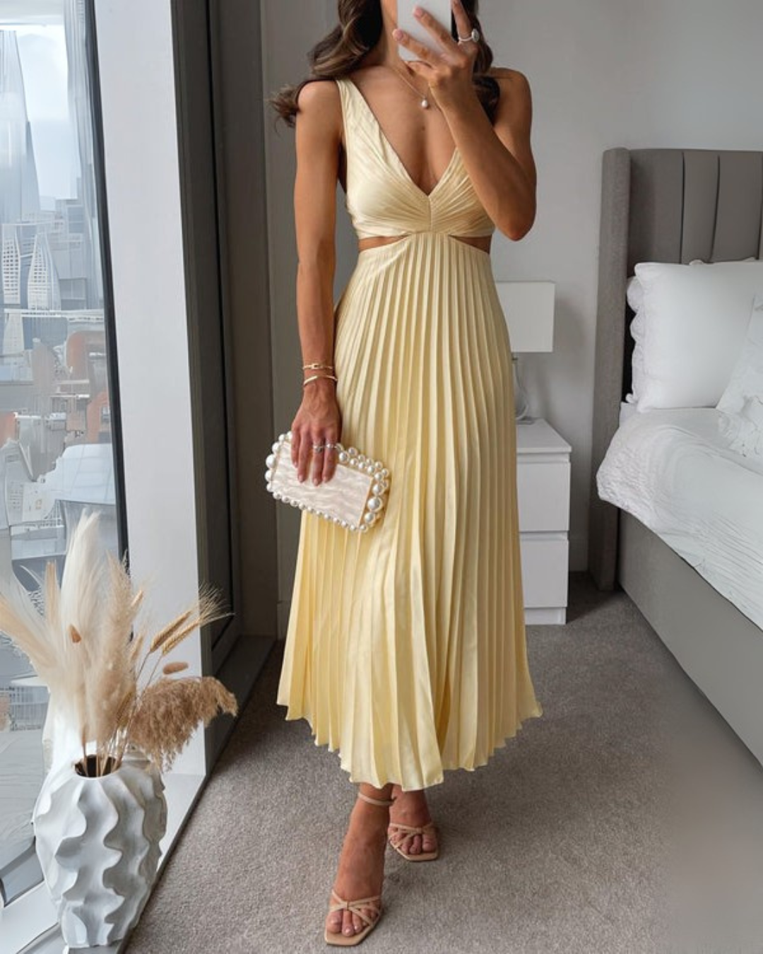 Yellow Madeleine Radiant Twist Dress from THE WHITMORE FAMILY, elegant sleeveless dress with twist detail, perfect for summer occasions.