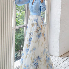 Light blue Audrey maxi dress by THE WHITMORE FAMILY featuring a vibrant floral print, flowing fabric, and elegant design.