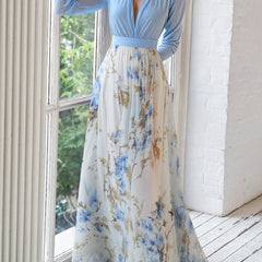Light blue Audrey maxi dress by THE WHITMORE FAMILY featuring a vibrant floral print, flowing fabric, and elegant style.