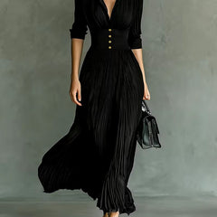 Black Joan elegant maxi dress by THE WHITMORE FAMILY, featuring flowing fabric and sophisticated design for formal occasions.