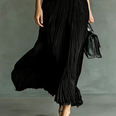Black Joan maxi dress by THE WHITMORE FAMILY, elegant long dress with flowing fabric and stylish design, perfect for formal occasions.