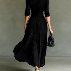 Black Joan elegant maxi dress by THE WHITMORE FAMILY, featuring flowing fabric and a stylish, sophisticated design.