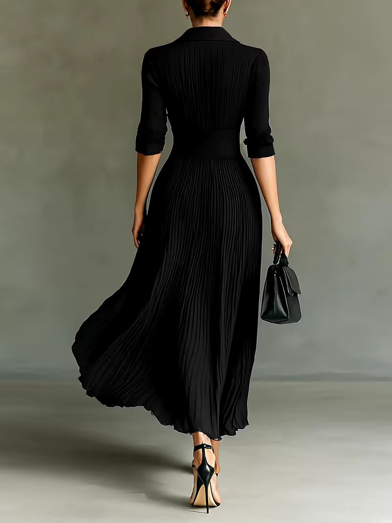 Black Joan elegant maxi dress by THE WHITMORE FAMILY, featuring flowing fabric and a stylish, sophisticated design.