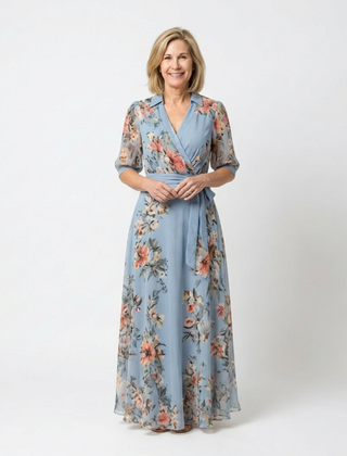 Elowen floral wrap V-neck maxi dress from THE WHITMORE FAMILY displayed in vibrant floral print on lightweight fabric.