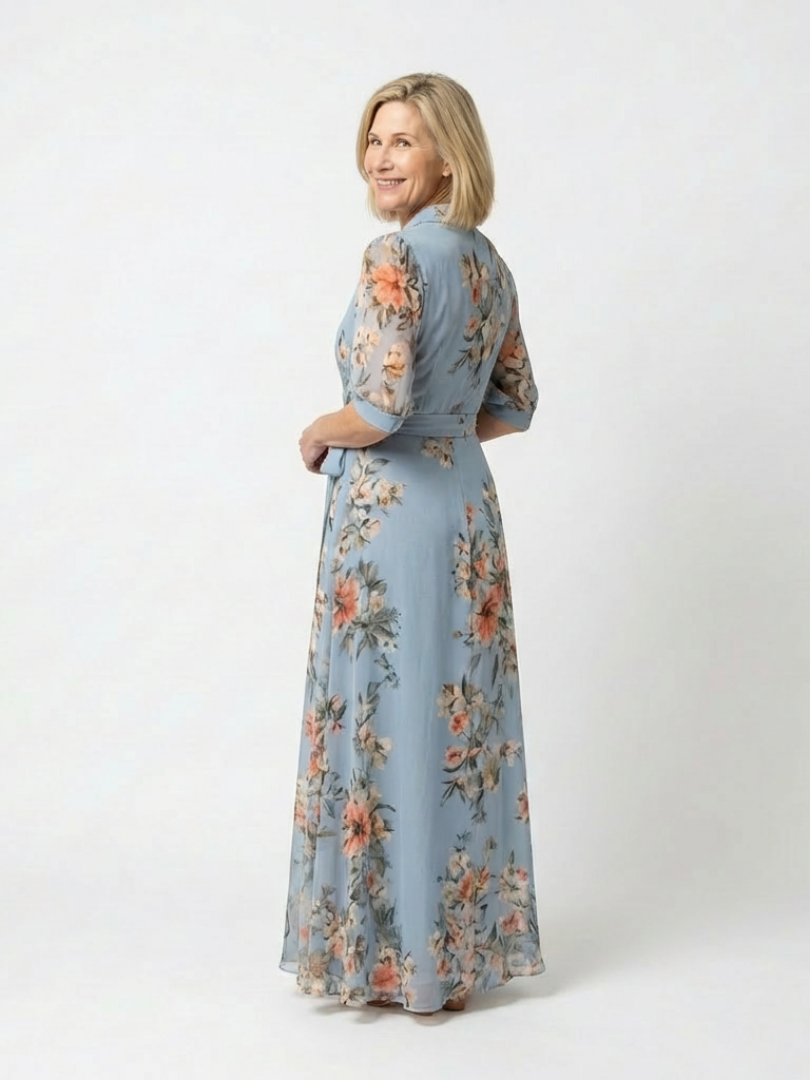 Elowen floral wrap V-neck maxi dress by THE WHITMORE FAMILY, showcasing a flowing fabric with a V neckline and floral pattern.