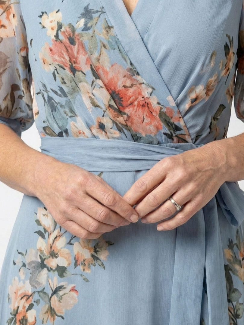 Elowen floral V-neck wrap maxi dress by THE WHITMORE FAMILY, featuring a flowing silhouette and vibrant floral pattern.