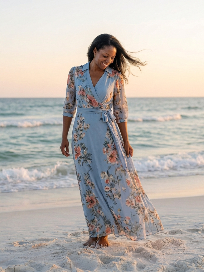 Floral wrap V-neck maxi dress by THE WHITMORE FAMILY featuring a flowing silhouette and vibrant floral pattern.