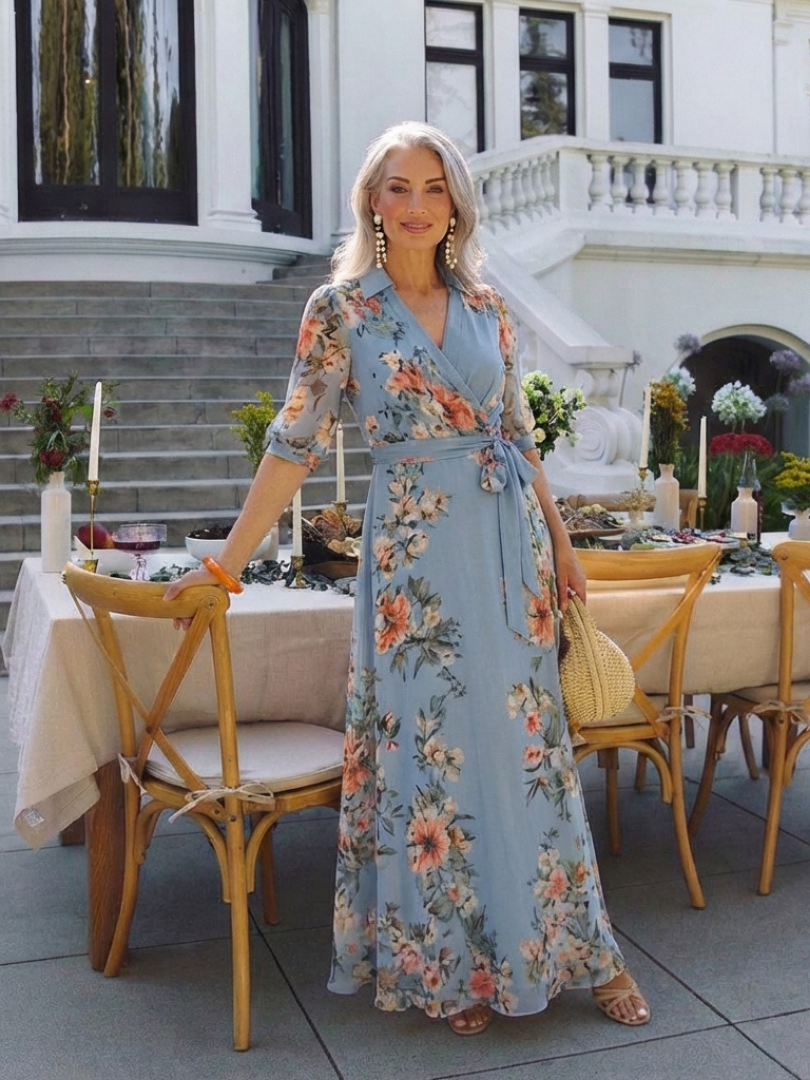 Elowen floral wrap V-neck maxi dress by THE WHITMORE FAMILY featuring a flowing skirt and vibrant floral pattern.
