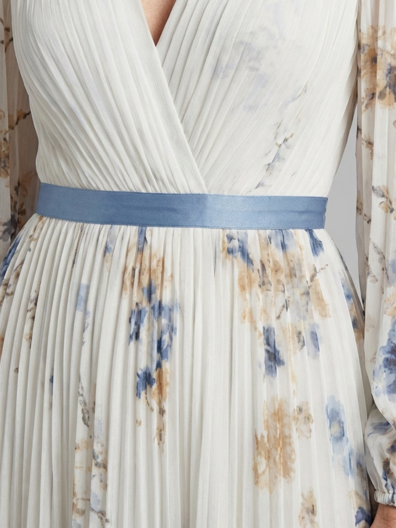 Lavinia long sleeve V-neck floral maxi dress by THE WHITMORE FAMILY, featuring a flowing silhouette and vibrant floral pattern.