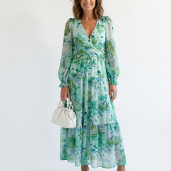 Althea long sleeve floral maxi dress by THE WHITMORE FAMILY, flowing fabric with vibrant floral pattern and elegant neckline.