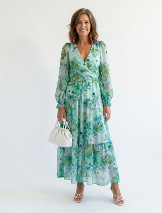 Althea long sleeve floral maxi dress by THE WHITMORE FAMILY, flowing fabric with vibrant floral pattern and elegant neckline.