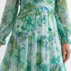 Long sleeve floral maxi dress by THE WHITMORE FAMILY featuring a flowing design and vibrant floral pattern.