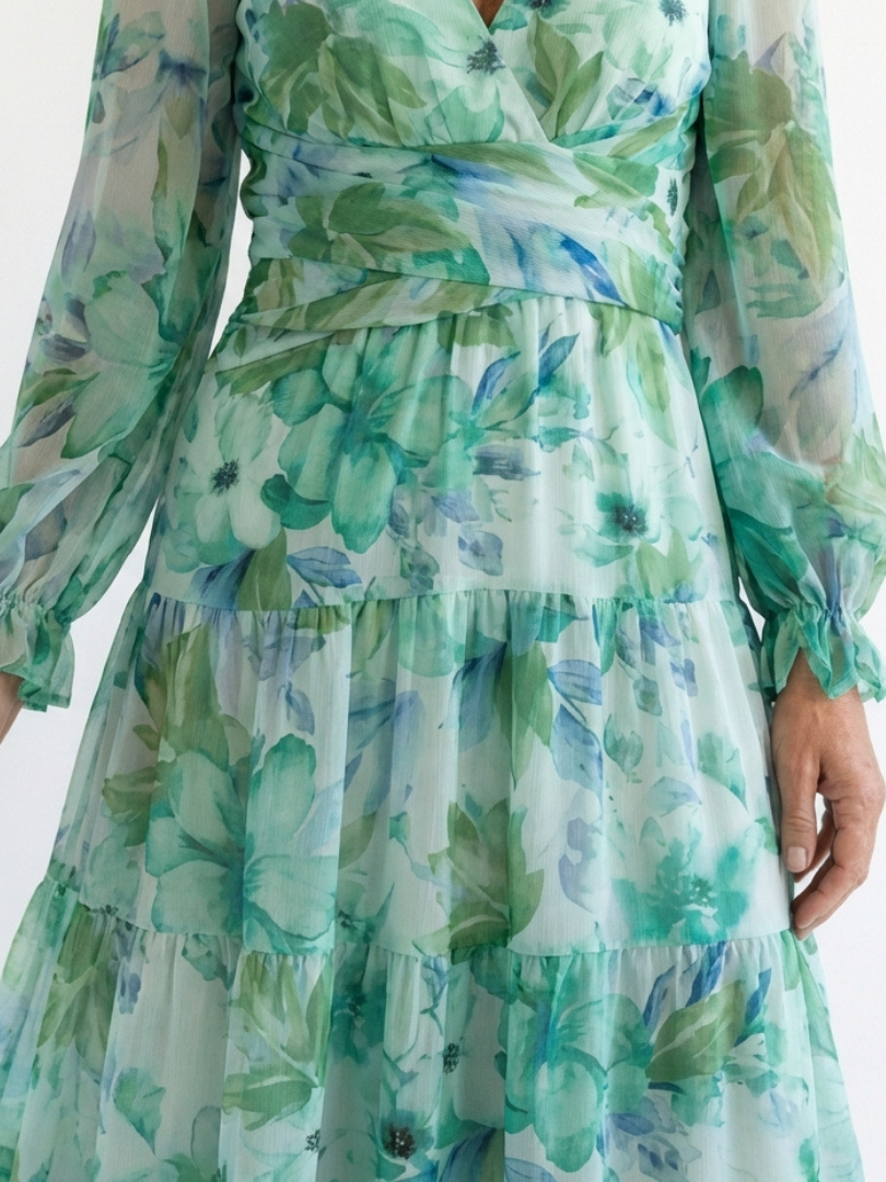 Long sleeve floral maxi dress by THE WHITMORE FAMILY featuring a flowing design and vibrant floral pattern.