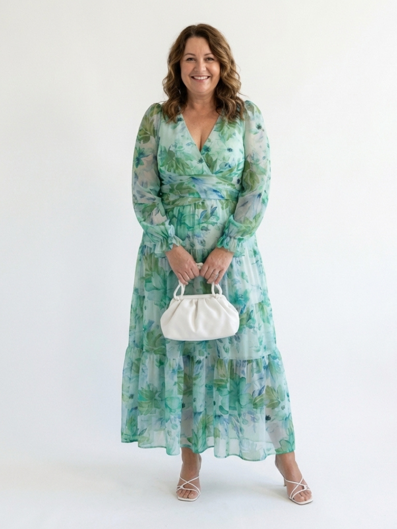 Long sleeve floral maxi dress by THE WHITMORE FAMILY, flowing fabric with a colorful floral pattern and fitted waist.