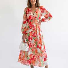 Althea long sleeve floral maxi dress by THE WHITMORE FAMILY featuring a flowing silhouette and vibrant floral pattern.
