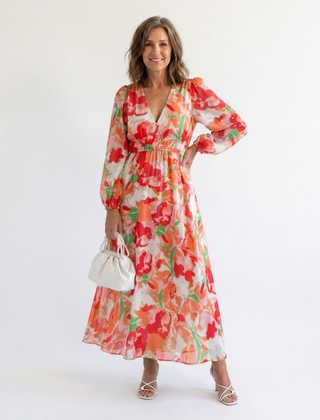 Althea long sleeve floral maxi dress by THE WHITMORE FAMILY featuring a flowing silhouette and vibrant floral pattern.