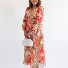 Althea long sleeve floral maxi dress by THE WHITMORE FAMILY featuring a flowing silhouette and vibrant floral pattern.
