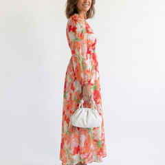Althea long sleeve floral maxi dress by THE WHITMORE FAMILY, featuring a flowing fabric with vibrant floral pattern.