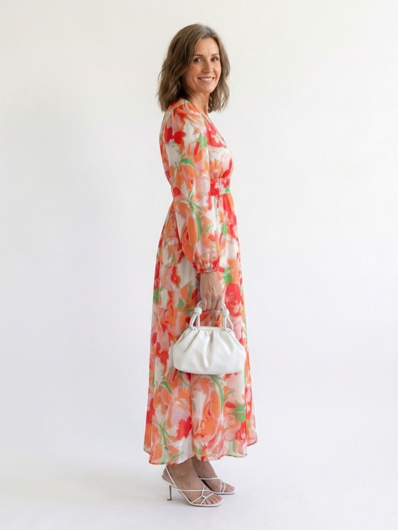 Althea long sleeve floral maxi dress by THE WHITMORE FAMILY, featuring a flowing fabric with vibrant floral pattern.