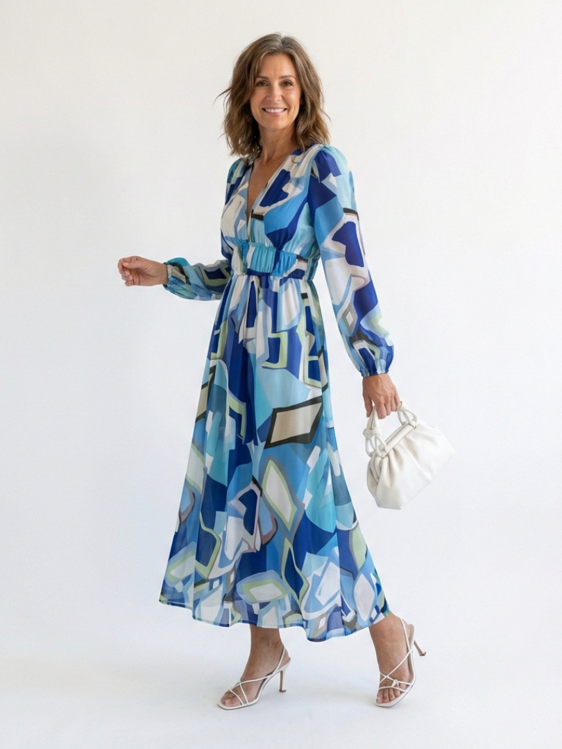 Long sleeve floral maxi dress by THE WHITMORE FAMILY featuring a flowing silhouette and vibrant floral pattern.
