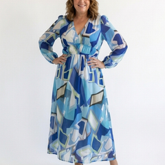 Long sleeve floral maxi dress from THE WHITMORE FAMILY featuring a flowing silhouette and vibrant floral pattern.