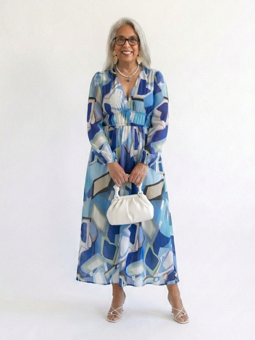 Long sleeve floral maxi dress by THE WHITMORE FAMILY featuring a flowing fabric and vibrant floral pattern.
