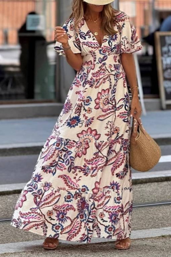 Purple floral print maxi dress with puff sleeves from THE WHITMORE FAMILY's Joan collection, shown on a model.