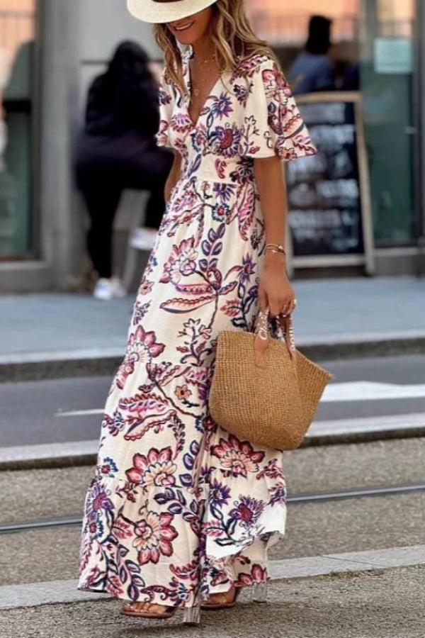 Purple floral print maxi dress with puff sleeves from THE WHITMORE FAMILY, featuring a flowing silhouette and elegant design.