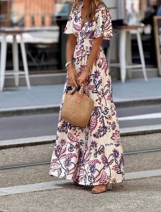Purple floral print maxi dress with puff sleeves, Joan by THE WHITMORE FAMILY, shown with a flowing, elegant design.