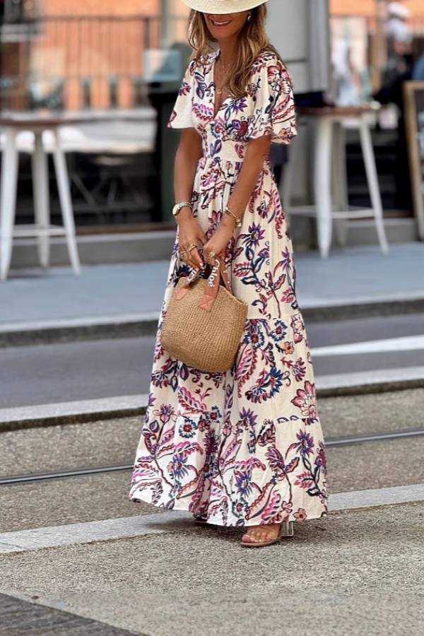 Purple floral print maxi dress with puff sleeves, Joan by THE WHITMORE FAMILY, shown with a flowing, elegant design.