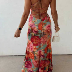 Red floral backless satin maxi dress by THE WHITMORE FAMILY, featuring elegant design and flowing fabric.