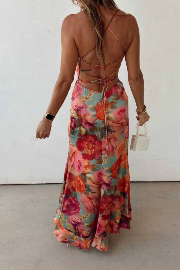 Red floral backless satin maxi dress by THE WHITMORE FAMILY, featuring elegant design and flowing fabric.