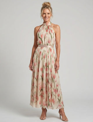 Aurelle halter neck floral midi dress from THE WHITMORE FAMILY featuring a fitted bodice and flowing skirt on a model.