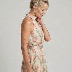 Aurelle floral midi dress by THE WHITMORE FAMILY featuring a halter neck and vibrant floral pattern on flowing fabric.