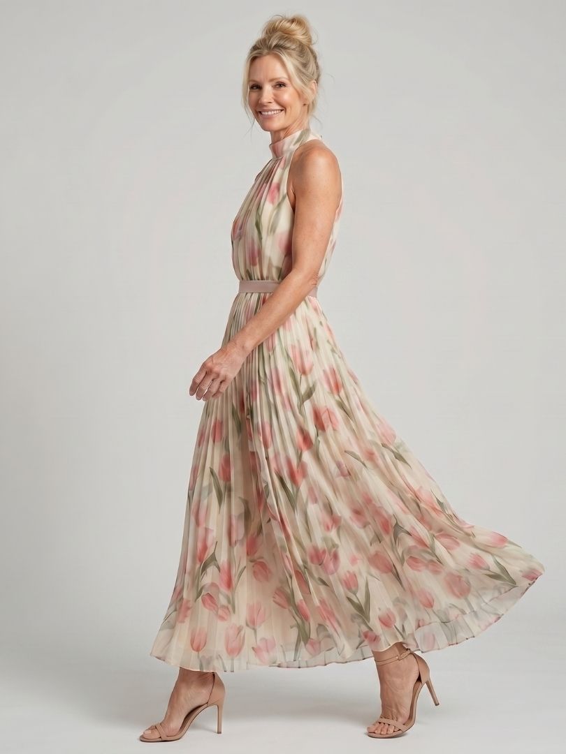 Aurelle halter neck floral midi dress by THE WHITMORE FAMILY, showcasing a fitted bodice and flowing skirt with vibrant floral pattern.