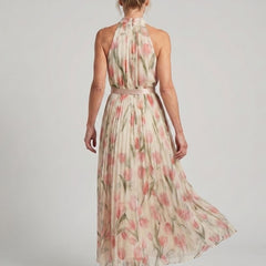 Aurelle halter neck floral midi dress by THE WHITMORE FAMILY, featuring a fitted bodice and flowing skirt with vibrant floral pattern.