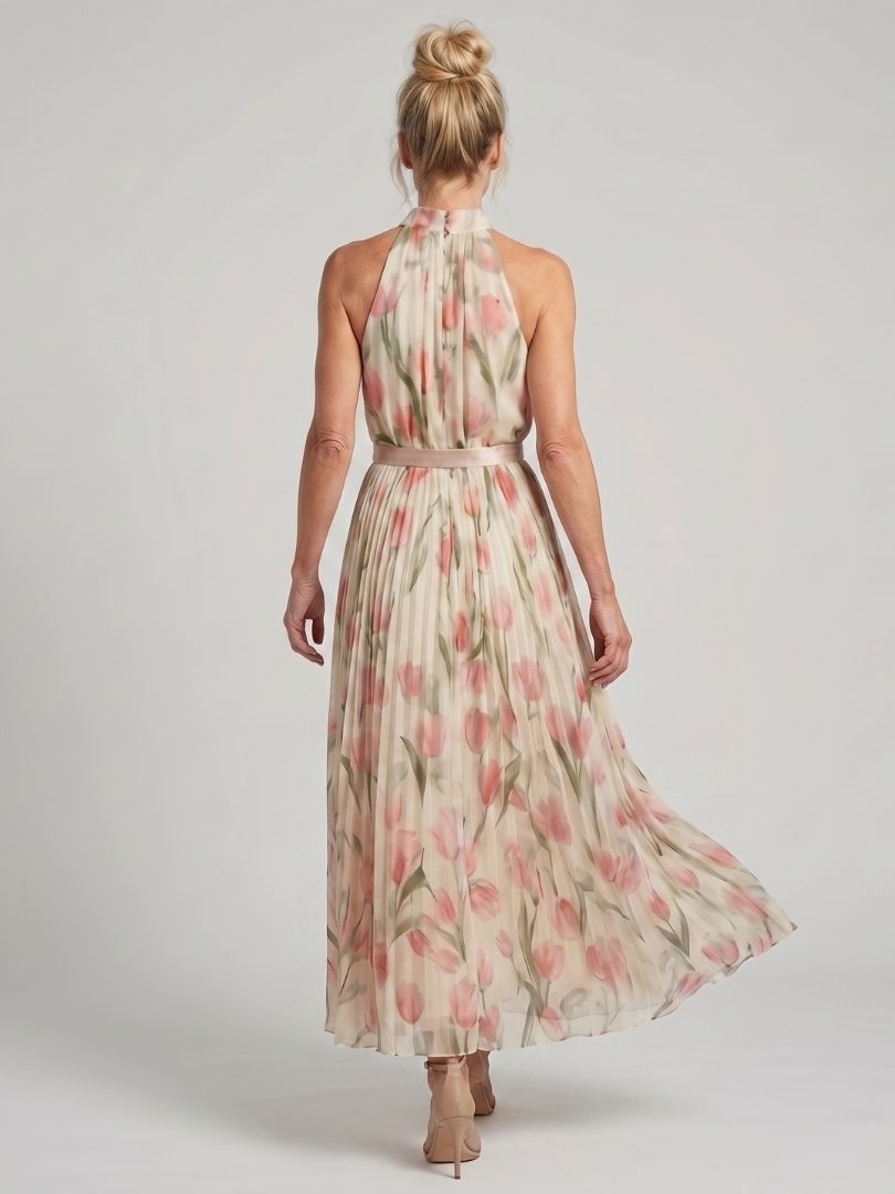 Aurelle halter neck floral midi dress by THE WHITMORE FAMILY, featuring a fitted bodice and flowing skirt with vibrant floral pattern.