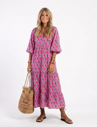 A patterned midi dress with three-quarter sleeves and a v-neck neckline by THE WHITMORE FAMILY, styled for spring or casual wear.