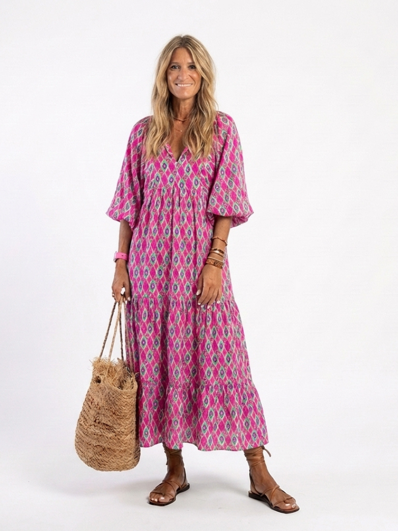 A patterned midi dress with three-quarter sleeves and a v-neck neckline by THE WHITMORE FAMILY, styled for spring or casual wear.