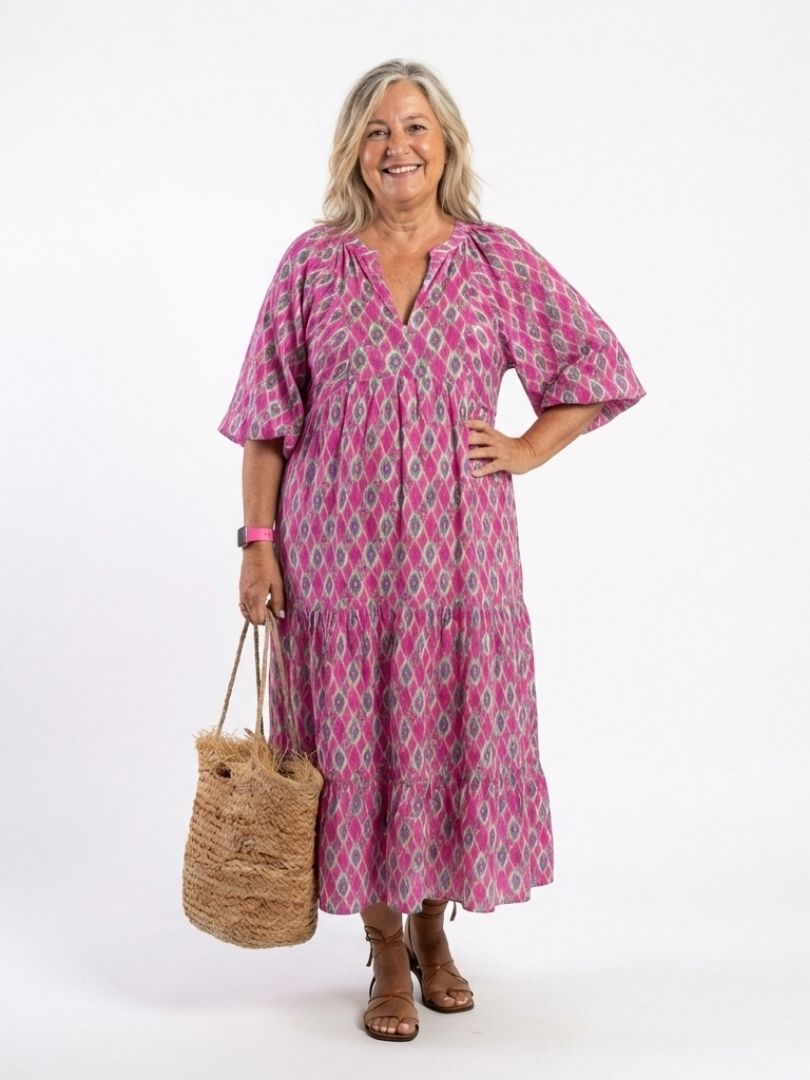 A woman wearing the Apolline midi dress with three-quarter sleeves, V-neck, and a patterned design suitable for spring or Easter occasions.