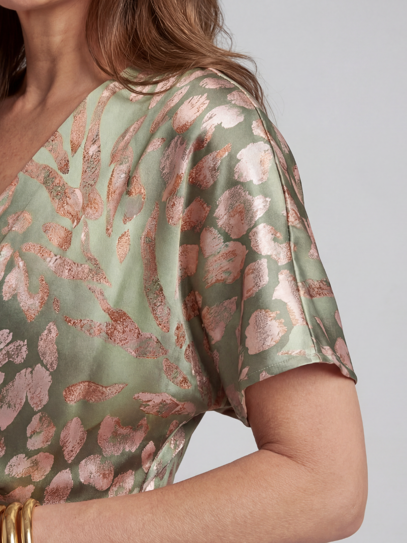 Coralie abstract print V neck twist waist midi dress by THE WHITMORE FAMILY, showcasing a flowing fabric and stylish design.