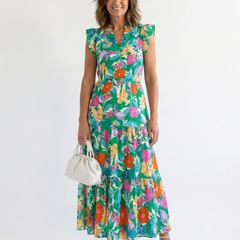Lila floral v-neck tiered midi dress by THE WHITMORE FAMILY, featuring a flowy silhouette and vibrant floral pattern.