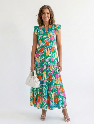 Lila floral v-neck tiered midi dress by THE WHITMORE FAMILY, featuring a flowy silhouette and vibrant floral pattern.