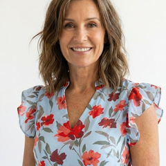 Lila floral v-neck tiered midi dress by THE WHITMORE FAMILY, featuring a flowy, tiered design with a vibrant floral pattern.