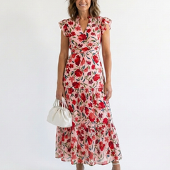 Lila floral v-neck tiered midi dress by THE WHITMORE FAMILY, shown with a flowy, tiered skirt and vibrant floral pattern.