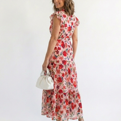Lila floral V-neck tiered midi dress by THE WHITMORE FAMILY, featuring a flowy silhouette and vibrant floral pattern.