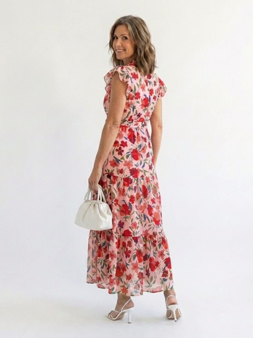 Lila floral V-neck tiered midi dress by THE WHITMORE FAMILY, featuring a flowy silhouette and vibrant floral pattern.