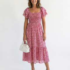Odette off-shoulder floral smocked midi dress by THE WHITMORE FAMILY, featuring a flowy silhouette and feminine floral print.