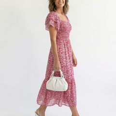 Odette off-shoulder floral smocked midi dress by THE WHITMORE FAMILY, featuring a feminine design with floral pattern and smocked waist.
